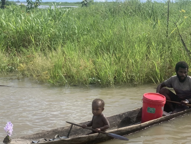 Cute photo of this young boy trying to fish...